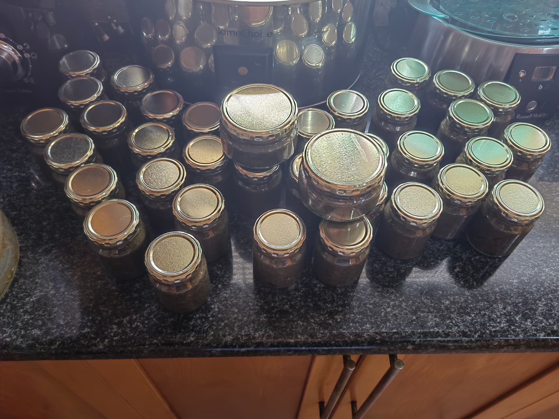 A completed batch of Sanyu Hair Growth Balm — jars sealed and ready