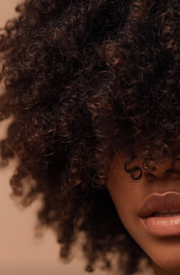 Close study of thriving natural curls in warm light