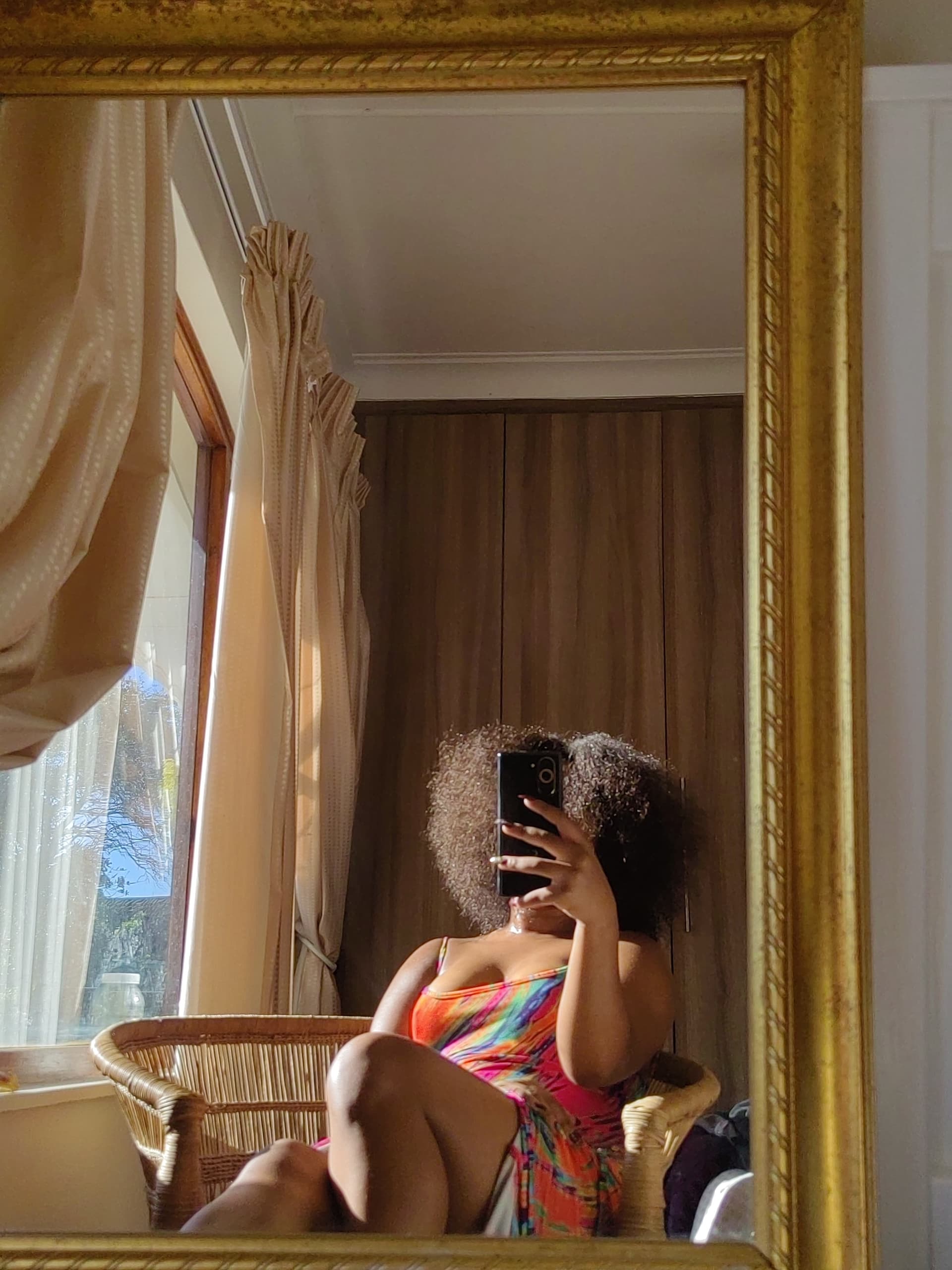 The founder at home in East London, natural afro full and unstraightened