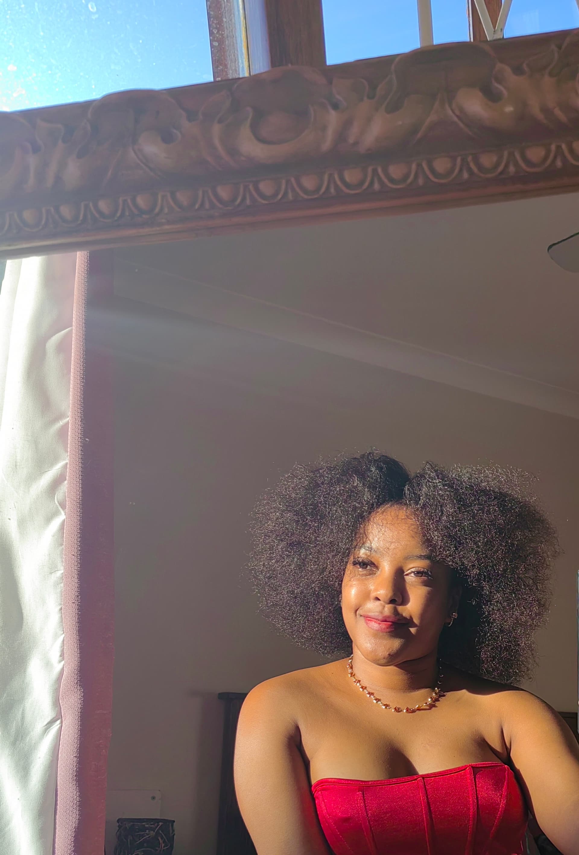 Nandawula Regine Kabali-Kagwa — the founder, wearing the afro her own oil grew back